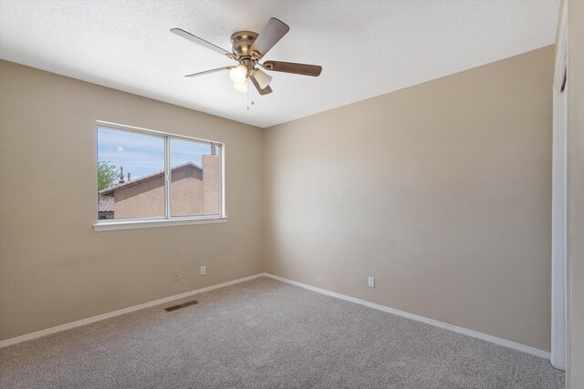 10516 Calle Sombra NW, Albuquerque, NM 87114 - carpeted empty room with ceiling fan, baseboards, and visible vents