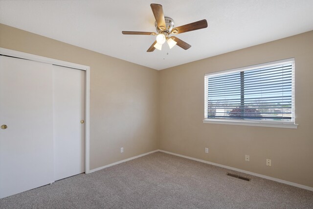 10516 Calle Sombra NW, Albuquerque, NM 87114 - unfurnished bedroom with a ceiling fan, a closet, carpet floors, baseboards, and visible vents
