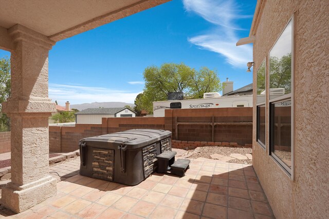 10516 Calle Sombra NW, Albuquerque, NM 87114 - view of patio / terrace with a fenced backyard and a hot tub