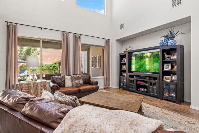 4024 Colina Roja Ln NE, Rio Rancho, NM 87124 - living area with plenty of natural light, baseboards, wood finished floors, and a high ceiling