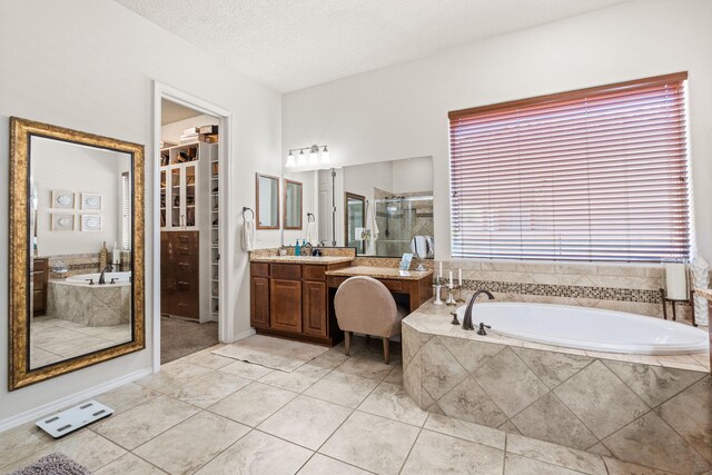 4024 Colina Roja Ln NE, Rio Rancho, NM 87124 - full bathroom with vanity, tile patterned floors, a stall shower, and a bath