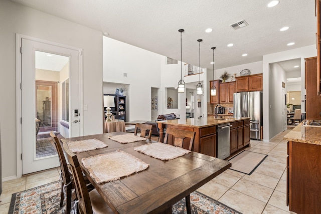 dining area featuring recessed lighting, a textured ceiling, visible vents, and light tile patterned flooring