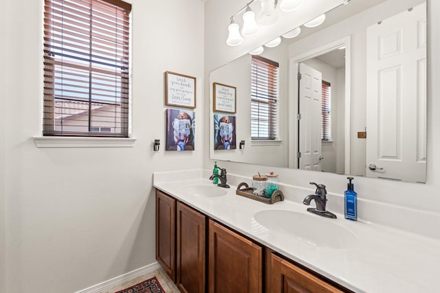 4024 Colina Roja Ln NE, Rio Rancho, NM 87124 - bathroom featuring double vanity and baseboards