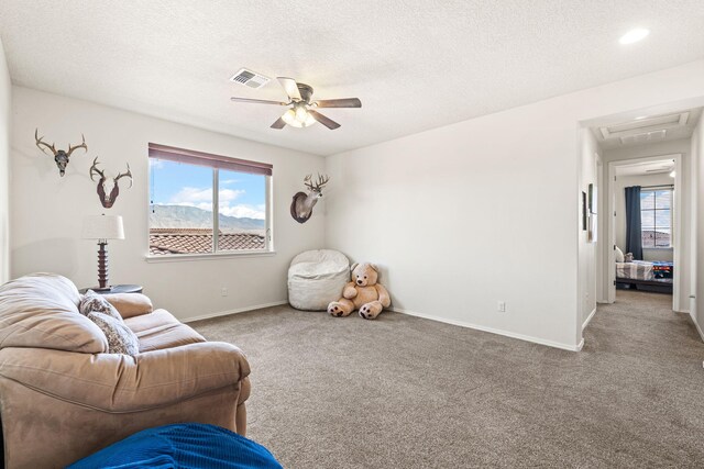 4024 Colina Roja Ln NE, Rio Rancho, NM 87124 - living area with ceiling fan, carpet floors, baseboards, and a textured ceiling