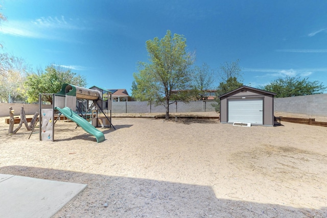 view of playground with a storage shed, fence, and an outdoor structure
