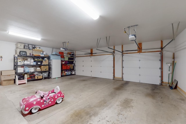 garage featuring a garage door opener and refrigerator