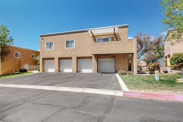 4701 Morris St NE Unit 3703, Albuquerque, NM 87111 - view of property with driveway, a garage, and stucco siding