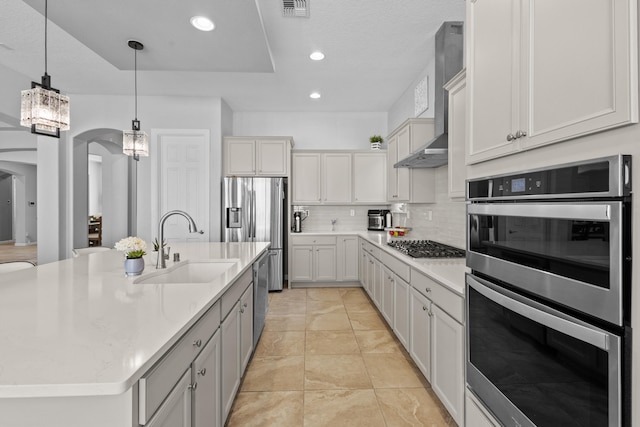 12209 Bear Valley Ln NW, Albuquerque, NM 87120 - kitchen with tasteful backsplash, a sink, arched walkways, appliances with stainless steel finishes, and visible vents