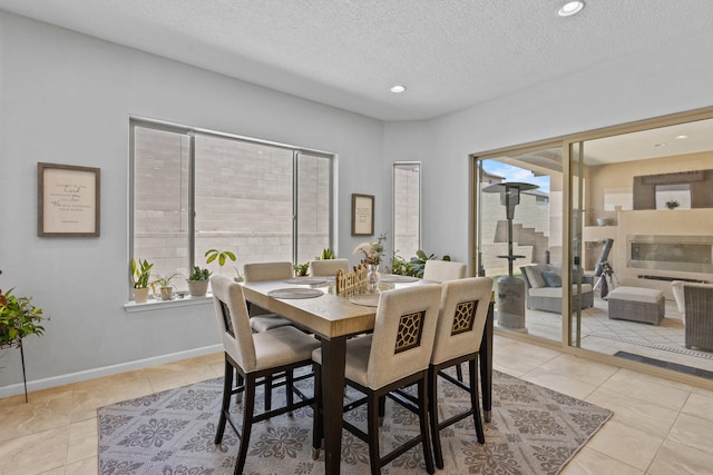 12209 Bear Valley Ln NW, Albuquerque, NM 87120 - dining space with baseboards, a textured ceiling, recessed lighting, and light tile patterned floors
