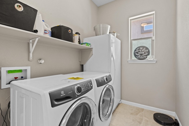 12209 Bear Valley Ln NW, Albuquerque, NM 87120 - clothes washing area featuring washing machine and clothes dryer, baseboards, laundry area, and light tile patterned flooring