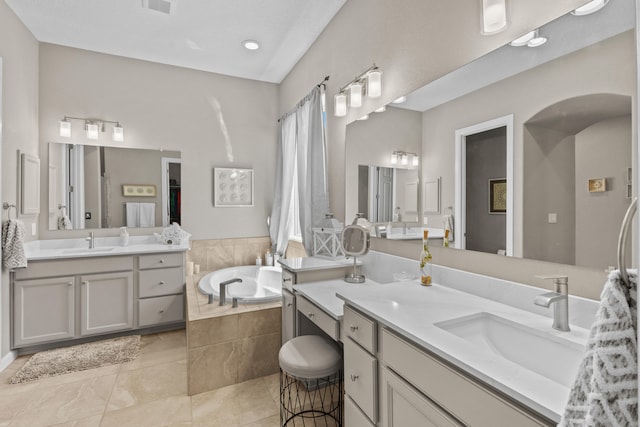 12209 Bear Valley Ln NW, Albuquerque, NM 87120 - bathroom featuring two vanities, a garden tub, tile patterned floors, and a sink