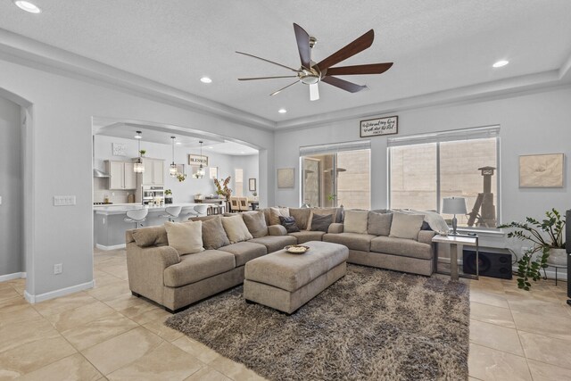 12209 Bear Valley Ln NW, Albuquerque, NM 87120 - living area with arched walkways, a ceiling fan, light tile patterned flooring, and recessed lighting