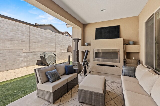 12209 Bear Valley Ln NW, Albuquerque, NM 87120 - view of patio / terrace with an outdoor living space with a fireplace and fence
