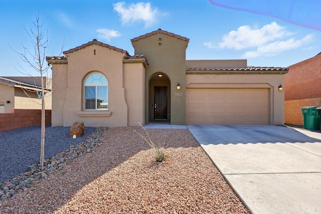 5002 Scope, Rio Rancho, NM 87144 - mediterranean / spanish-style house with a tiled roof, a garage, stucco siding, and driveway