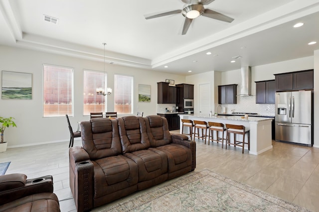 5002 Scope, Rio Rancho, NM 87144 - living room featuring a tray ceiling, ceiling fan with notable chandelier, recessed lighting, and visible vents