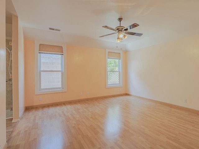 7417 Maplewood Dr NW, Albuquerque, NM 87120 - spare room with ceiling fan, baseboards, wood finished floors, and visible vents