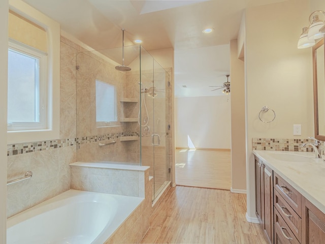 7417 Maplewood Dr NW, Albuquerque, NM 87120 - bathroom with a stall shower, baseboards, wood finished floors, a garden tub, and vanity