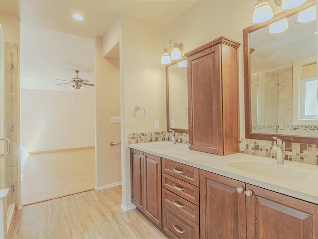 7417 Maplewood Dr NW, Albuquerque, NM 87120 - full bathroom featuring wood finished floors, tiled shower, ceiling fan, and a sink