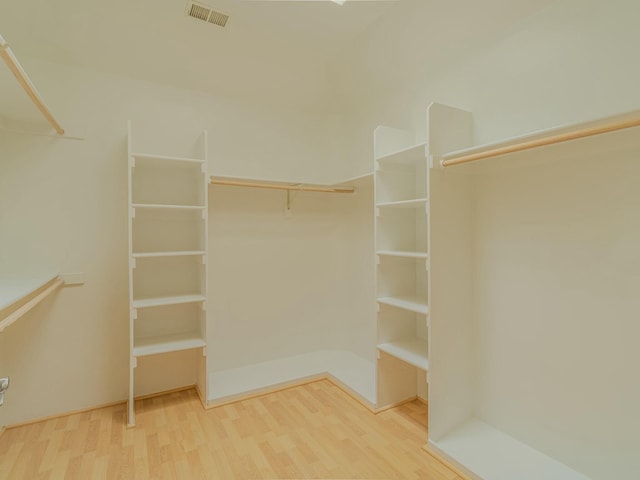 7417 Maplewood Dr NW, Albuquerque, NM 87120 - walk in closet with wood finished floors and visible vents
