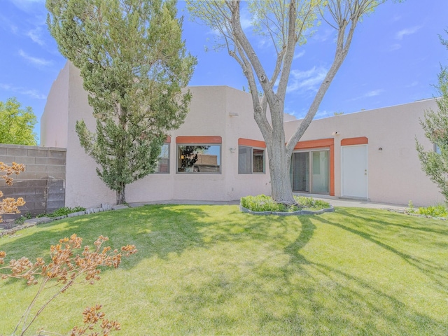 7417 Maplewood Dr NW, Albuquerque, NM 87120 - view of front of home with fence, a front yard, and stucco siding