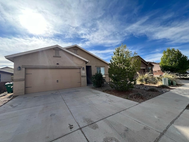 ranch-style house with concrete driveway, stucco siding, and a garage