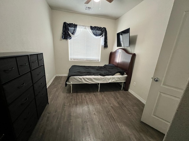 bedroom with a ceiling fan, dark wood-type flooring, baseboards, and visible vents