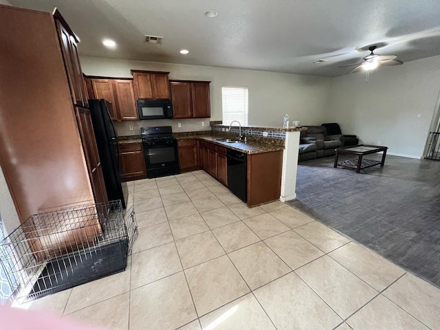 kitchen featuring ceiling fan, visible vents, a peninsula, open floor plan, and black appliances