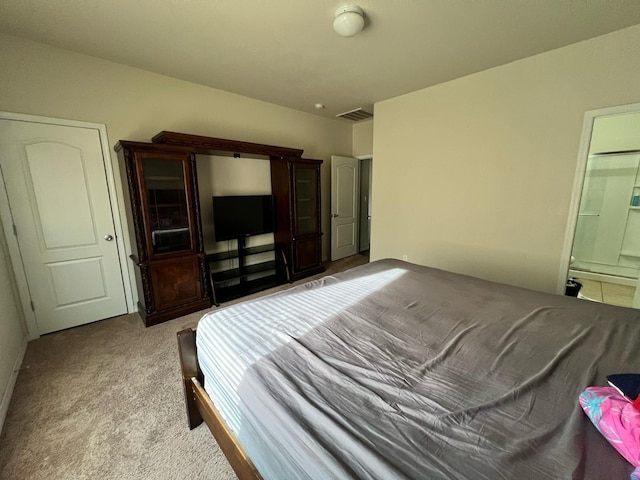 bedroom with carpet flooring and ensuite bath