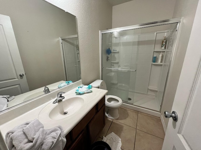 full bath featuring vanity, toilet, a shower stall, and tile patterned floors