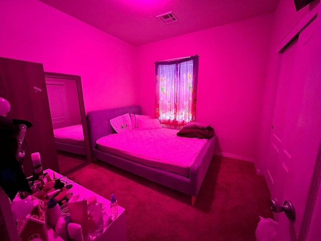 bedroom with visible vents and carpet floors