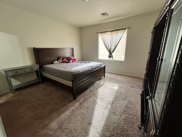 bedroom featuring visible vents, baseboards, and carpet floors