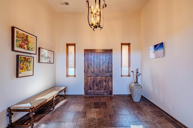 6 Storyteller Ct, Sandia Park, NM 87047 - foyer with dark stone finish flooring, a chandelier, and a towering ceiling