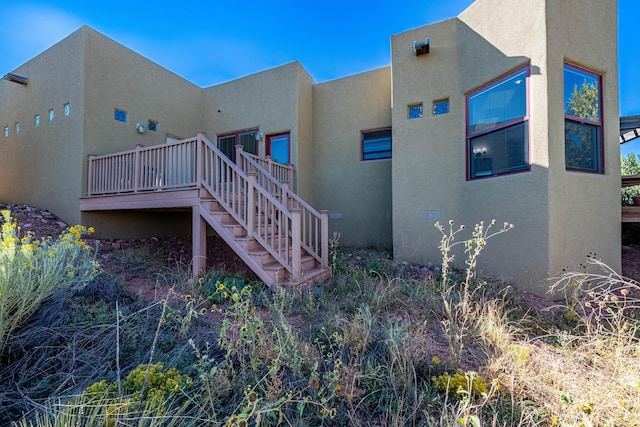 6 Storyteller Ct, Sandia Park, NM 87047 - view of side of home with stucco siding, stairway, and a deck