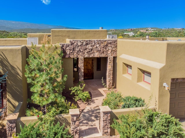 6 Storyteller Ct, Sandia Park, NM 87047 - doorway to property featuring stucco siding and a mountain view