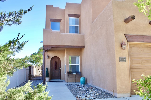 4201 High Mesa Rd SE, Rio Rancho, NM 87124 - doorway to property with a gate, stucco siding, and fence