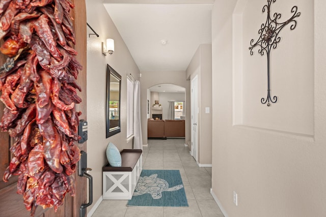 4201 High Mesa Rd SE, Rio Rancho, NM 87124 - hall featuring arched walkways, tile patterned flooring, and baseboards