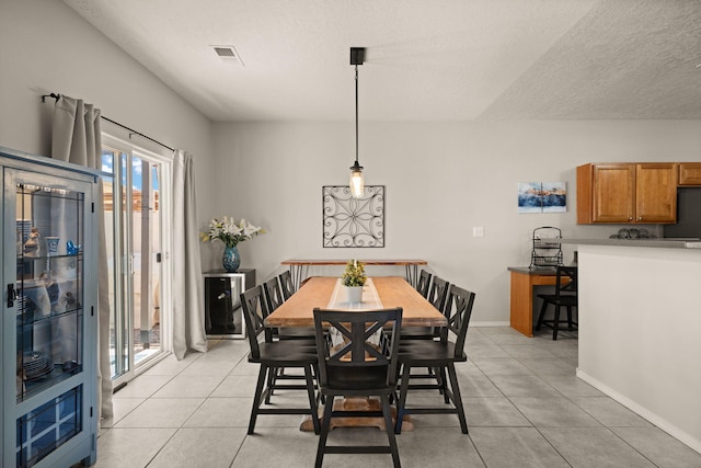 4201 High Mesa Rd SE, Rio Rancho, NM 87124 - dining area with light tile patterned floors, baseboards, and a textured ceiling