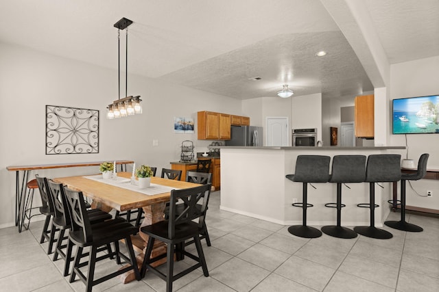 4201 High Mesa Rd SE, Rio Rancho, NM 87124 - dining room featuring a textured ceiling, light tile patterned floors, baseboards, and recessed lighting