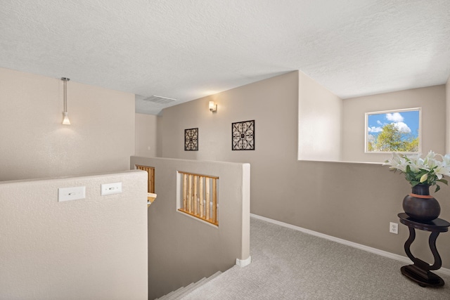 4201 High Mesa Rd SE, Rio Rancho, NM 87124 - hall with an upstairs landing, carpet floors, a textured ceiling, and baseboards