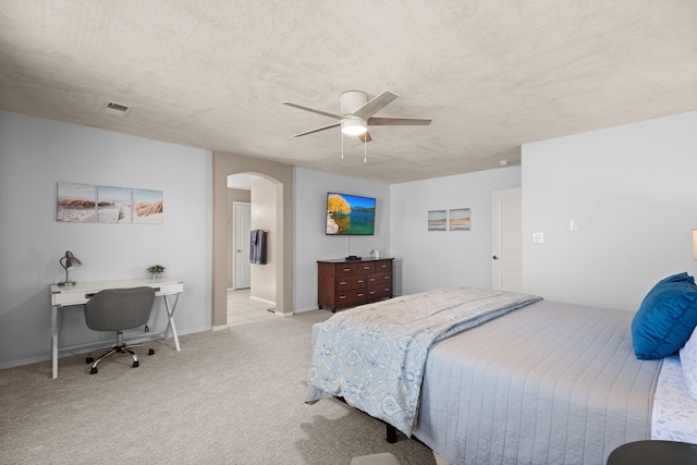 4201 High Mesa Rd SE, Rio Rancho, NM 87124 - bedroom featuring arched walkways, light colored carpet, a ceiling fan, a textured ceiling, and a desk
