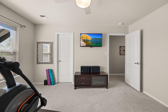 4201 High Mesa Rd SE, Rio Rancho, NM 87124 - workout room with light colored carpet, ceiling fan, baseboards, and a textured ceiling