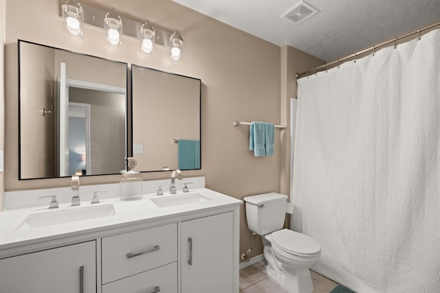 4201 High Mesa Rd SE, Rio Rancho, NM 87124 - full bath featuring toilet, tile patterned flooring, double vanity, a shower with shower curtain, and a textured ceiling