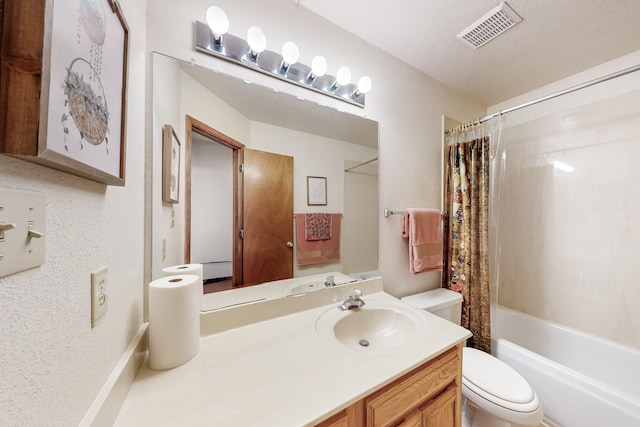 bathroom with visible vents, vanity, toilet, a textured wall, and shower / bath combo with shower curtain