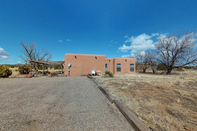 view of side of home with stucco siding