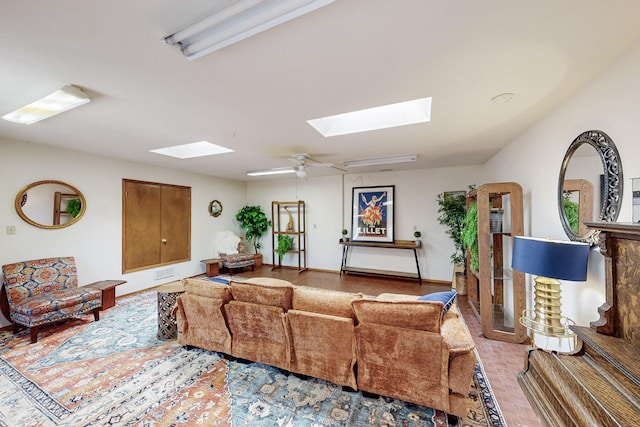 living room featuring visible vents, baseboards, and a skylight