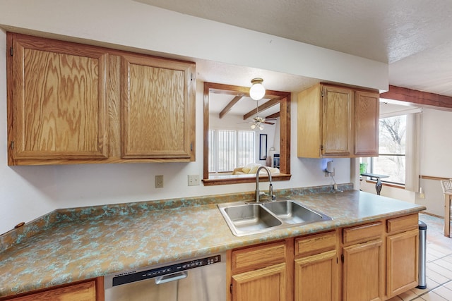 kitchen featuring ceiling fan, beam ceiling, a sink, a textured ceiling, and stainless steel dishwasher