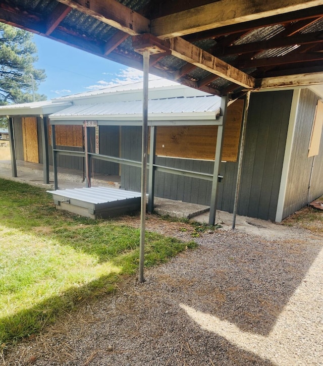 view of side of home with metal roof