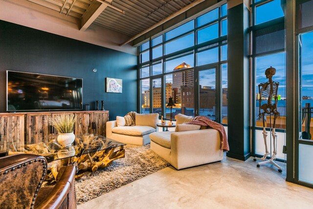 100 Gold Ave SW Unit 404, Albuquerque, NM 87102 - living room with concrete flooring, beamed ceiling, a city view, and a towering ceiling