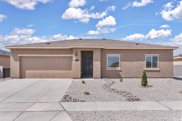 2507 Calle Del Los Claveles, Belen, NM 87002 - view of front of home with concrete driveway, an attached garage, and stucco siding