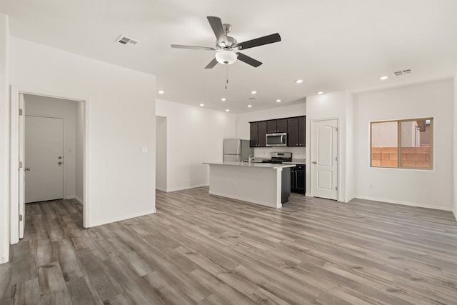 unfurnished living room with visible vents, a ceiling fan, light wood-style floors, and recessed lighting